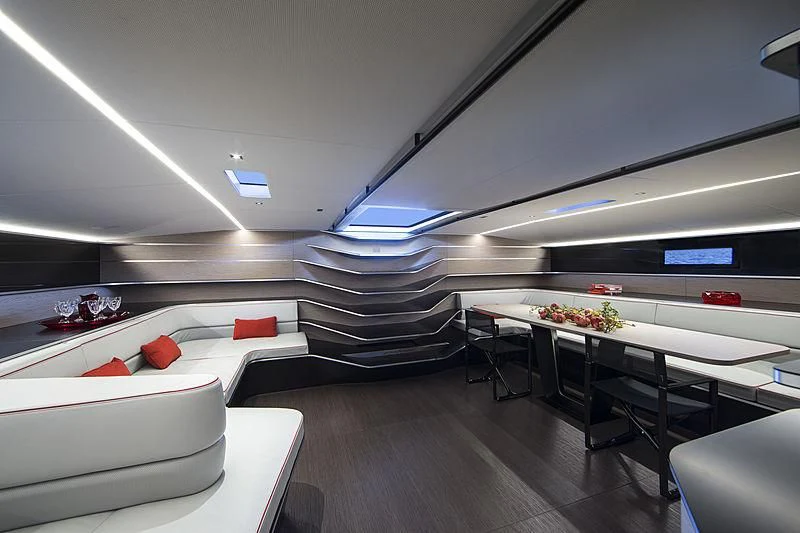 a room with a couch and a table with chairs aboard V Yacht for Sale