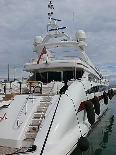 a white boat with a red stripe aboard SAMJA Yacht for Sale