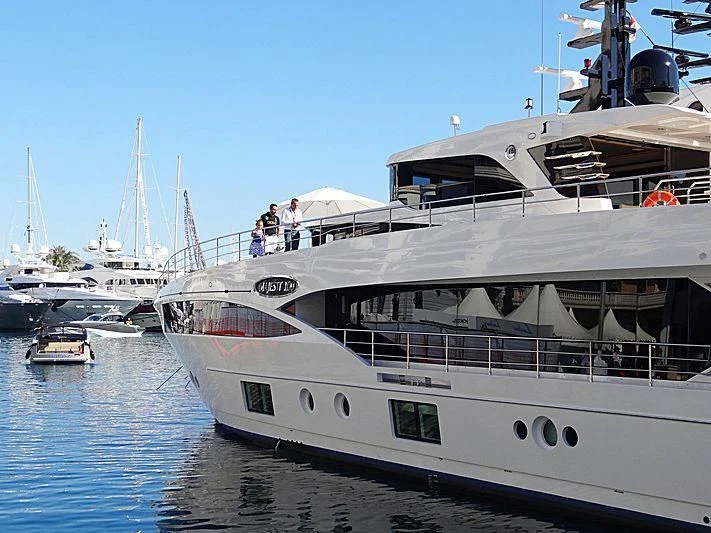 a large yacht docked at a pier aboard CAROBELLE Yacht for Sale