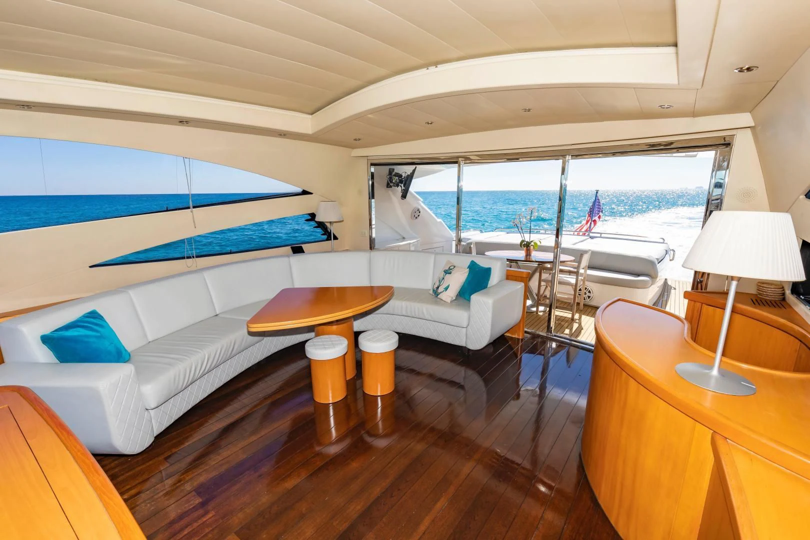 a room with a bed and a table with chairs and a window aboard FREE SPIRIT Yacht for Sale