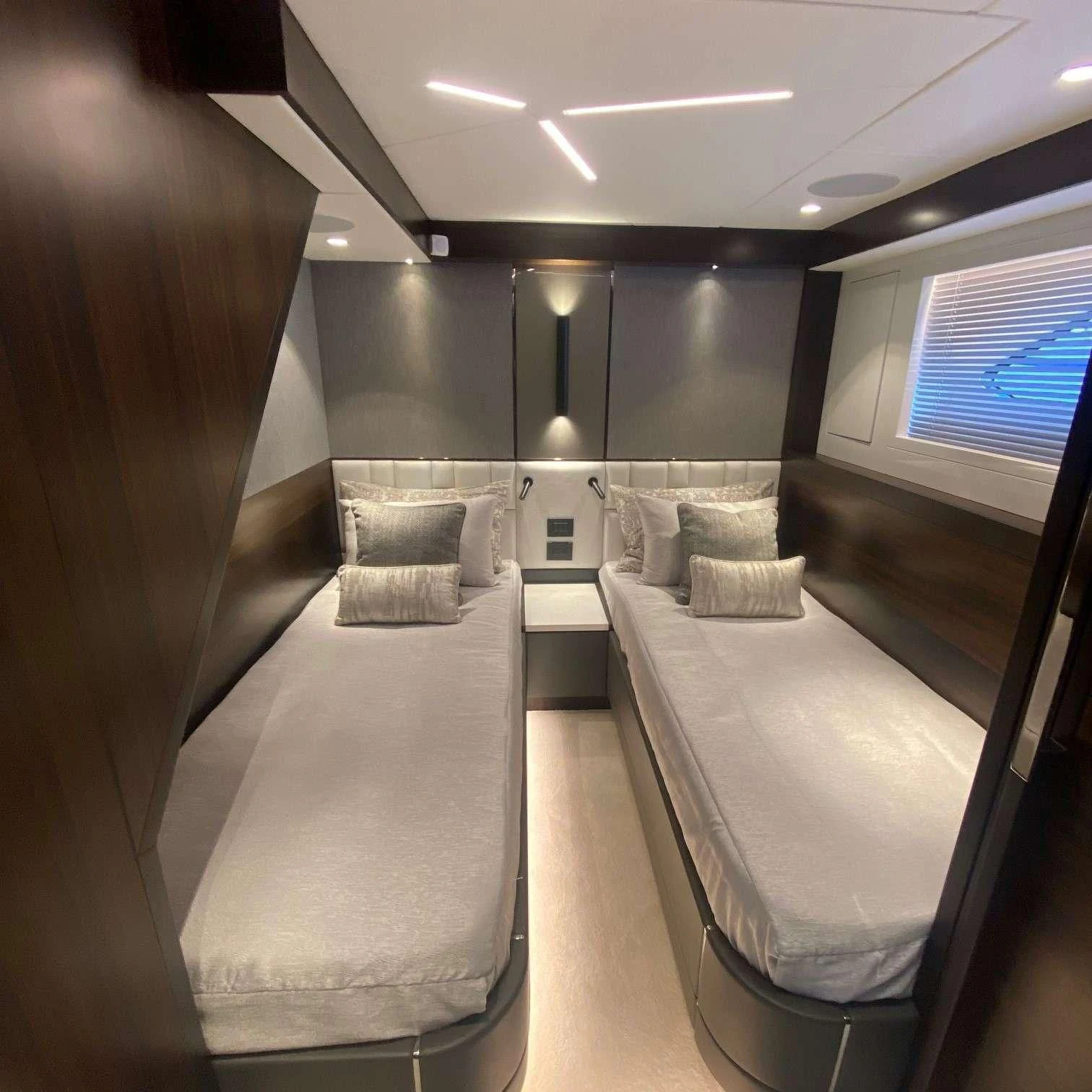 a room with several beds aboard LAGO PARADISE Yacht for Sale