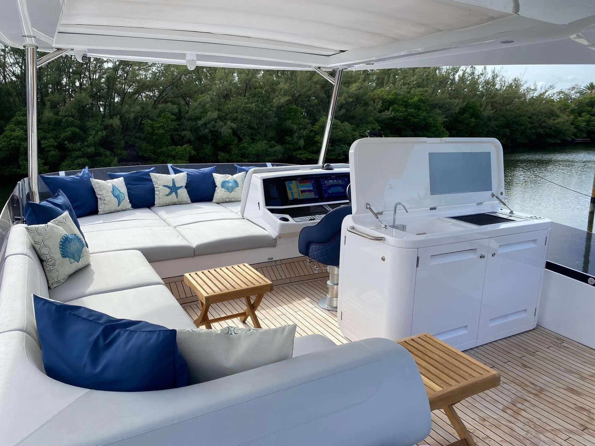 a white tent with a couch and a table and a white chair aboard LAGO PARADISE Yacht for Sale