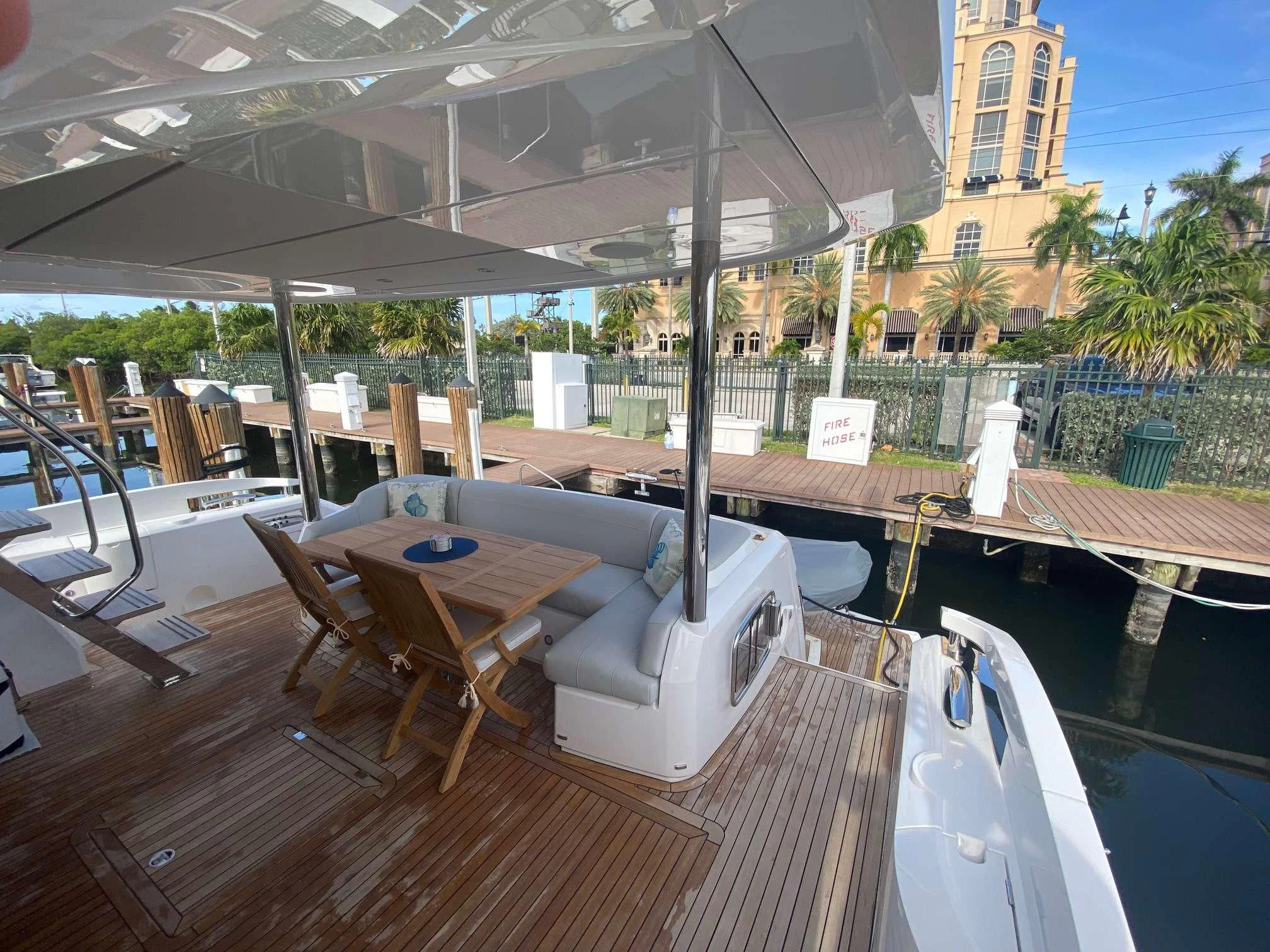 a deck with a pool and lounge chairs aboard LAGO PARADISE Yacht for Sale