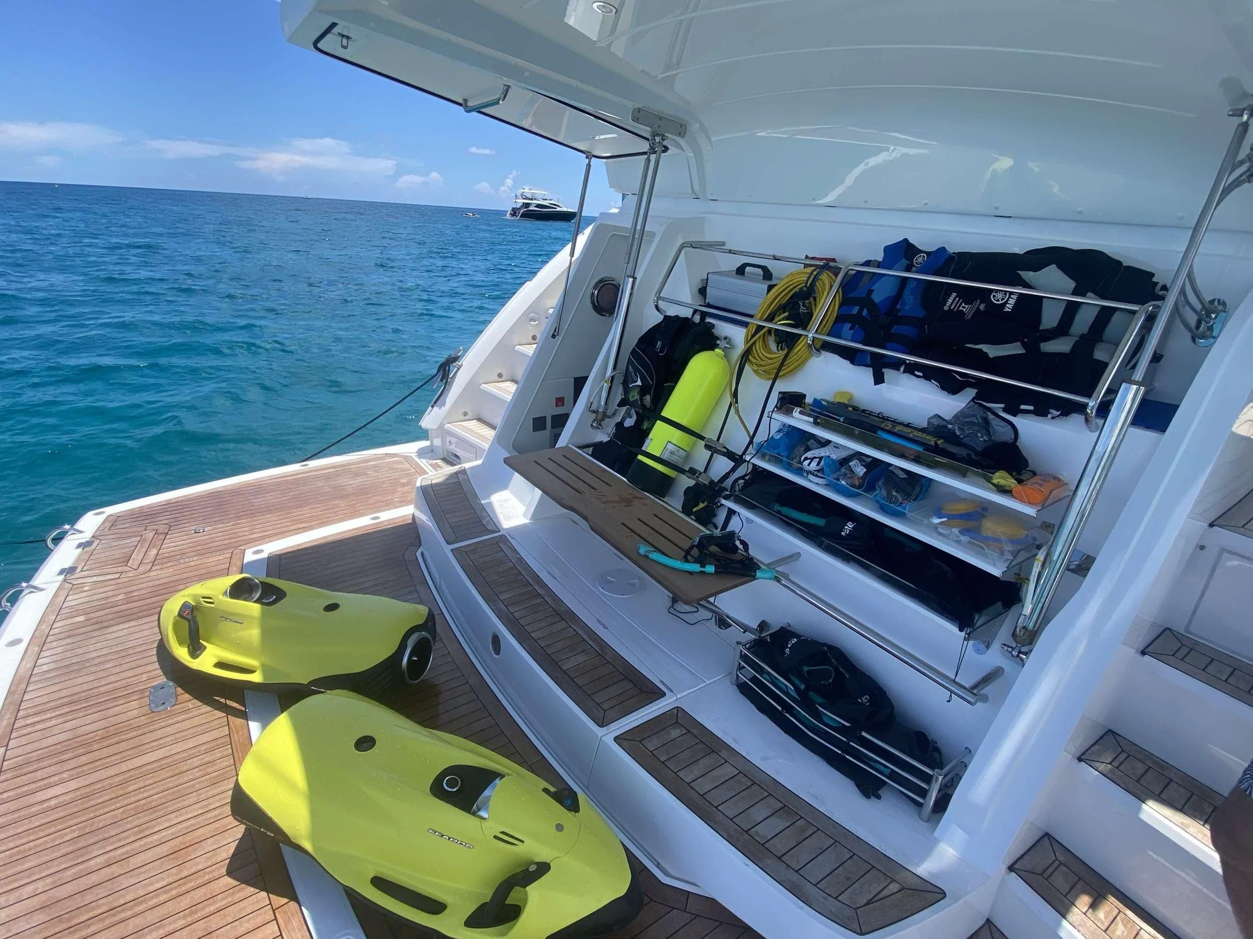 a boat with a green lawn chair on the deck aboard LAGO PARADISE Yacht for Sale