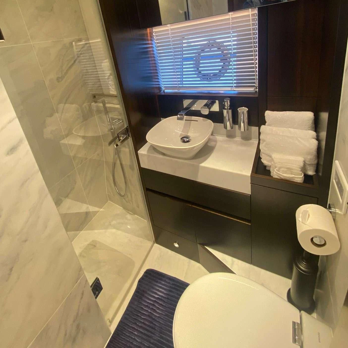a bathroom with a large mirror aboard LAGO PARADISE Yacht for Sale