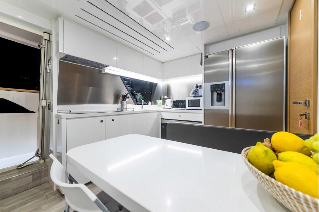 a kitchen with white cabinets aboard SEVEN Yacht for Sale