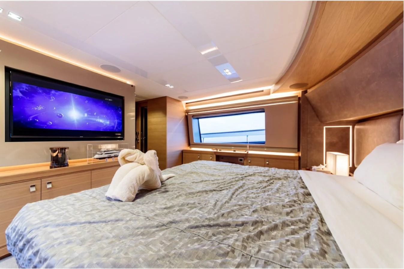 a bedroom with a television on the wall aboard SEVEN Yacht for Sale