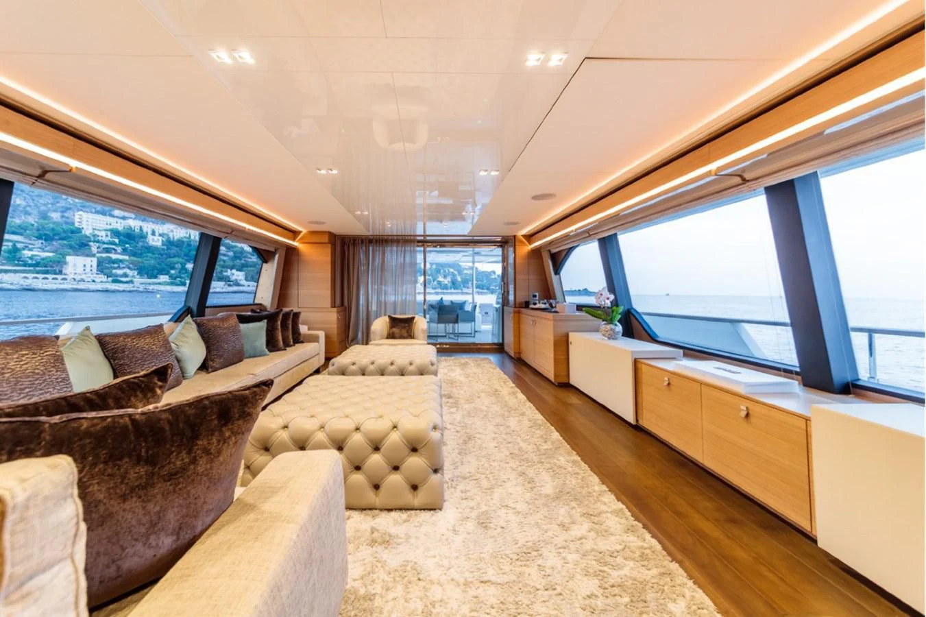 a living room with a couch and a large window aboard SEVEN Yacht for Sale