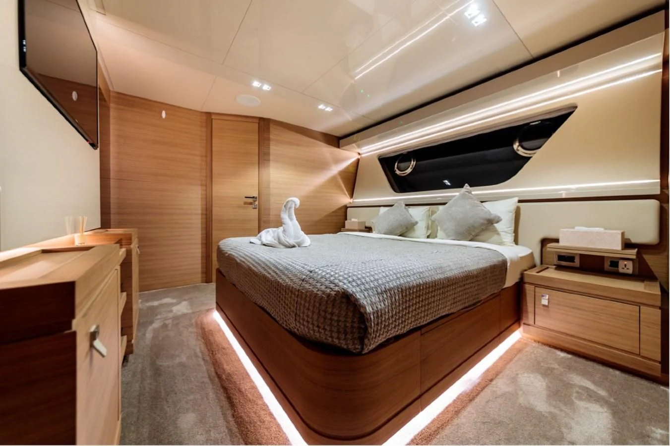 a bedroom with a bed and a dresser aboard SEVEN Yacht for Sale