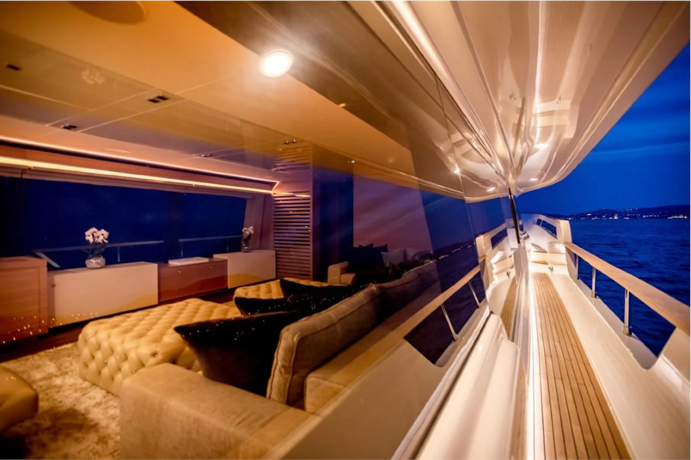 a room with a couch and a large window overlooking the water aboard SEVEN Yacht for Sale