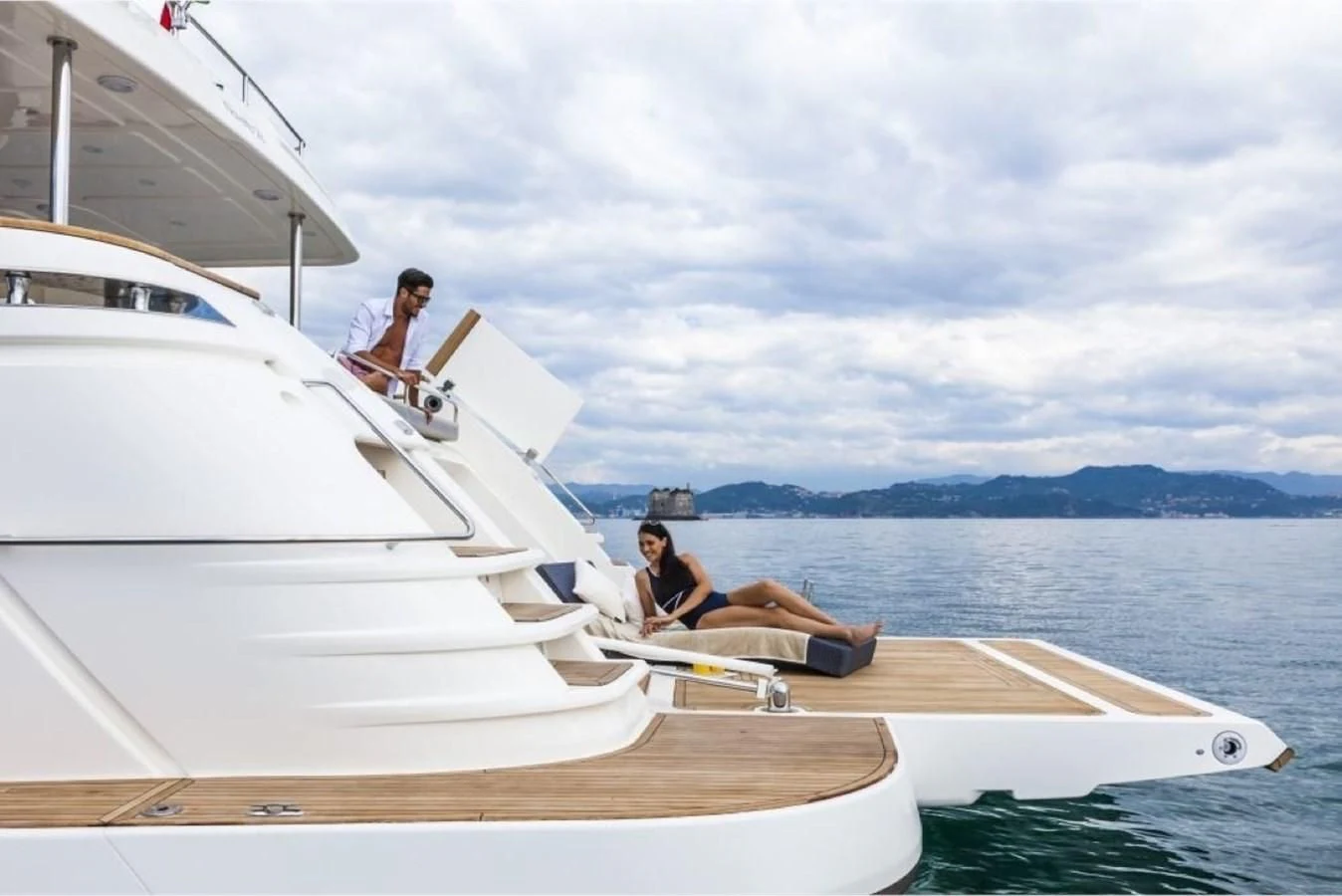 a couple of people sitting on a boat in the water aboard SEVEN Yacht for Sale