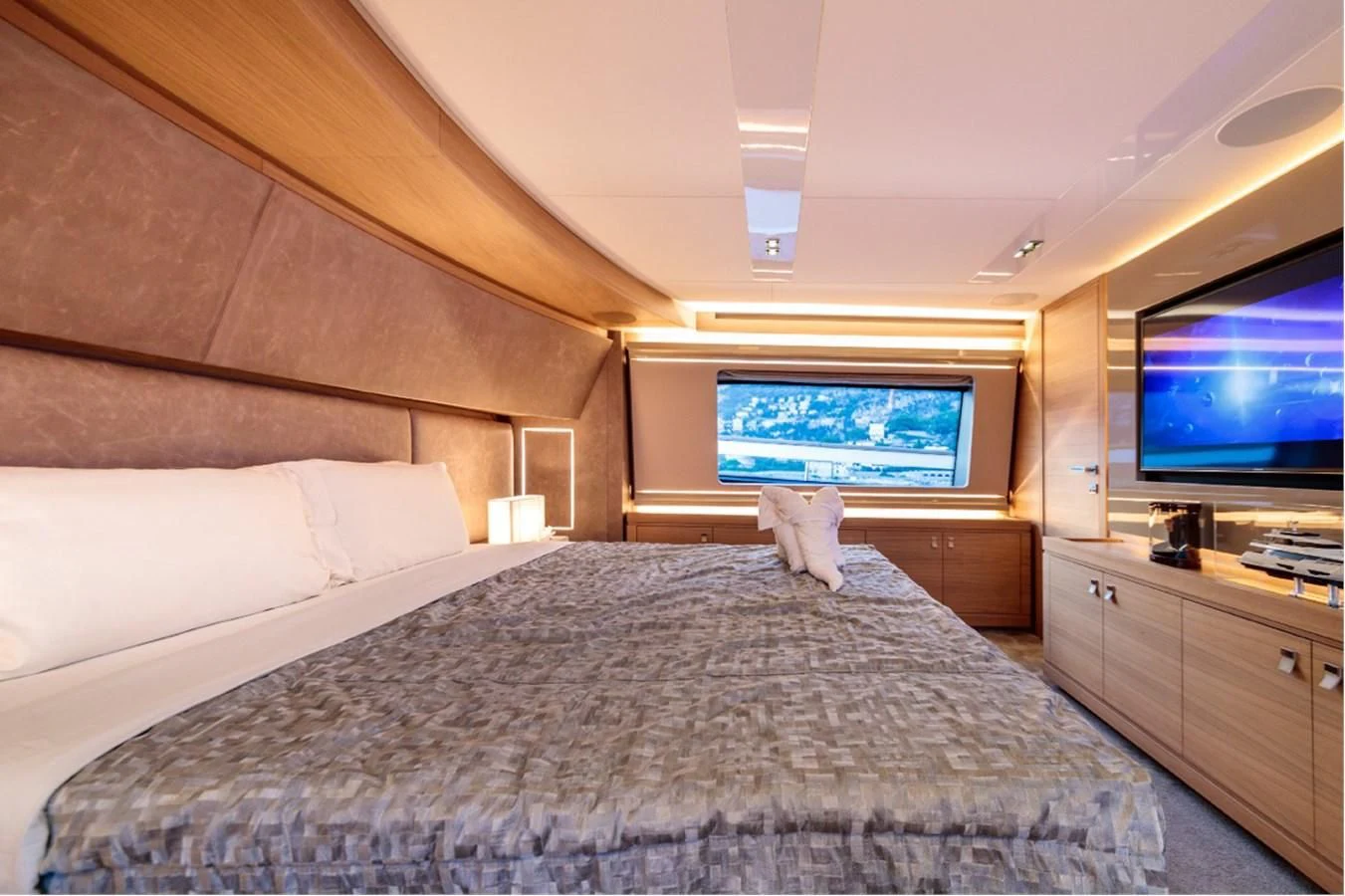 a person lying on a bed aboard SEVEN Yacht for Sale