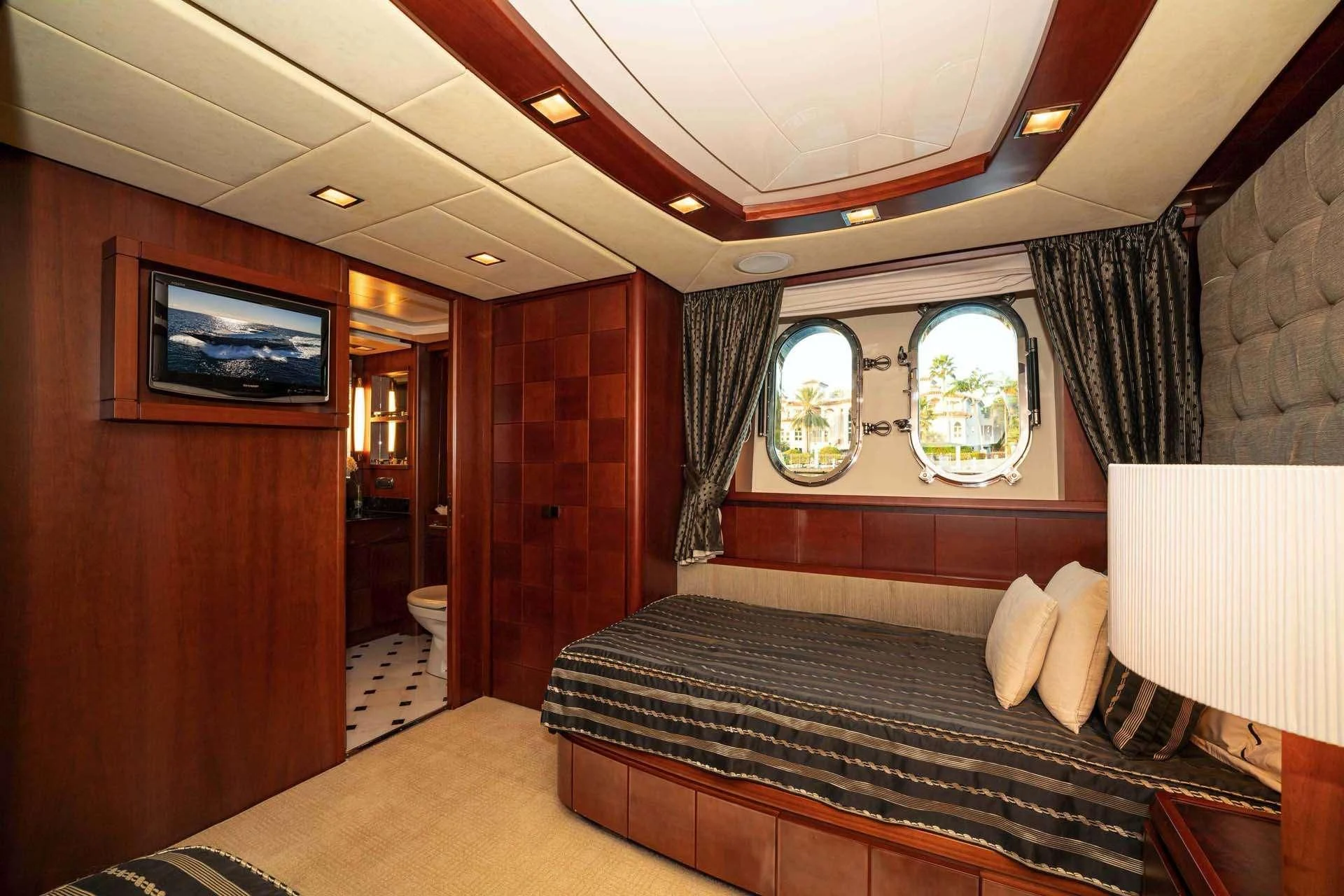 a room with a bed and a tv aboard VIVERE Yacht for Sale