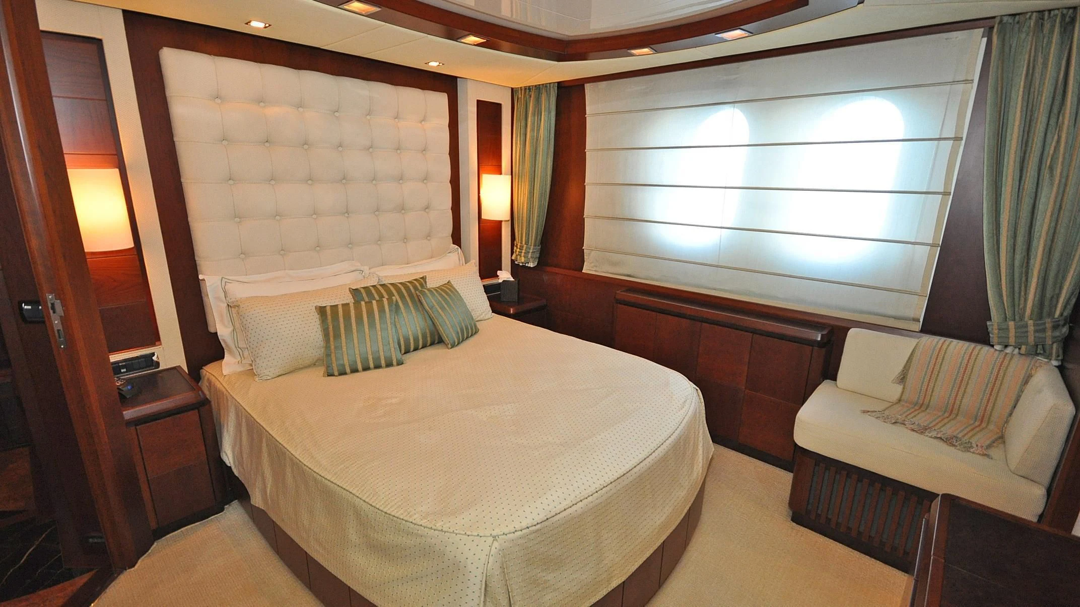 a room with a bed and a window aboard VIVERE Yacht for Sale