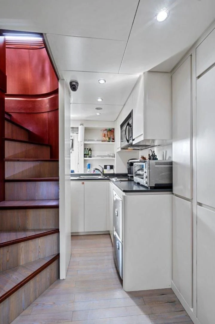 a kitchen with a red door aboard VIVERE Yacht for Sale