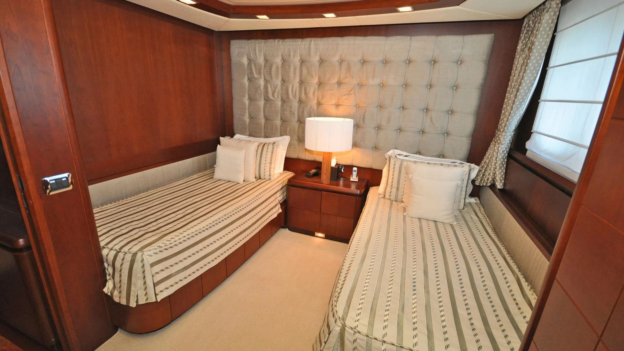 a room with a bed and a chair aboard VIVERE Yacht for Sale