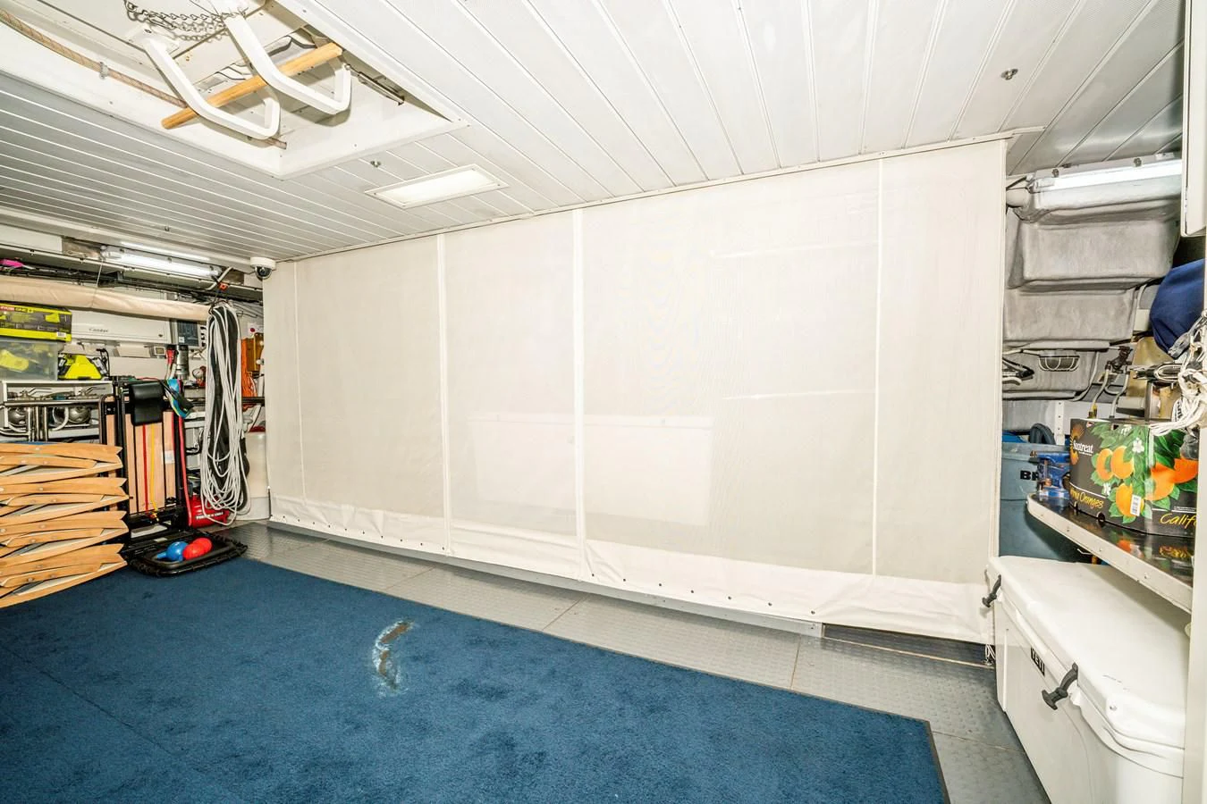 a room with a blue floor and white walls aboard VIVERE Yacht for Sale