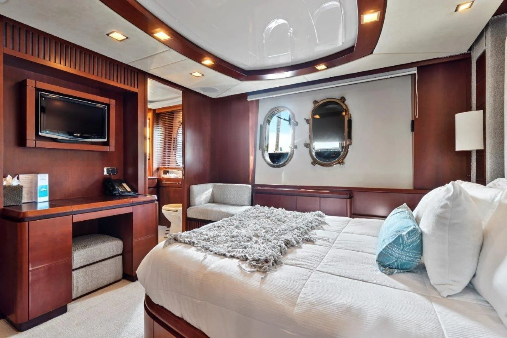 a hotel room with a bed and a tv aboard VIVERE Yacht for Sale