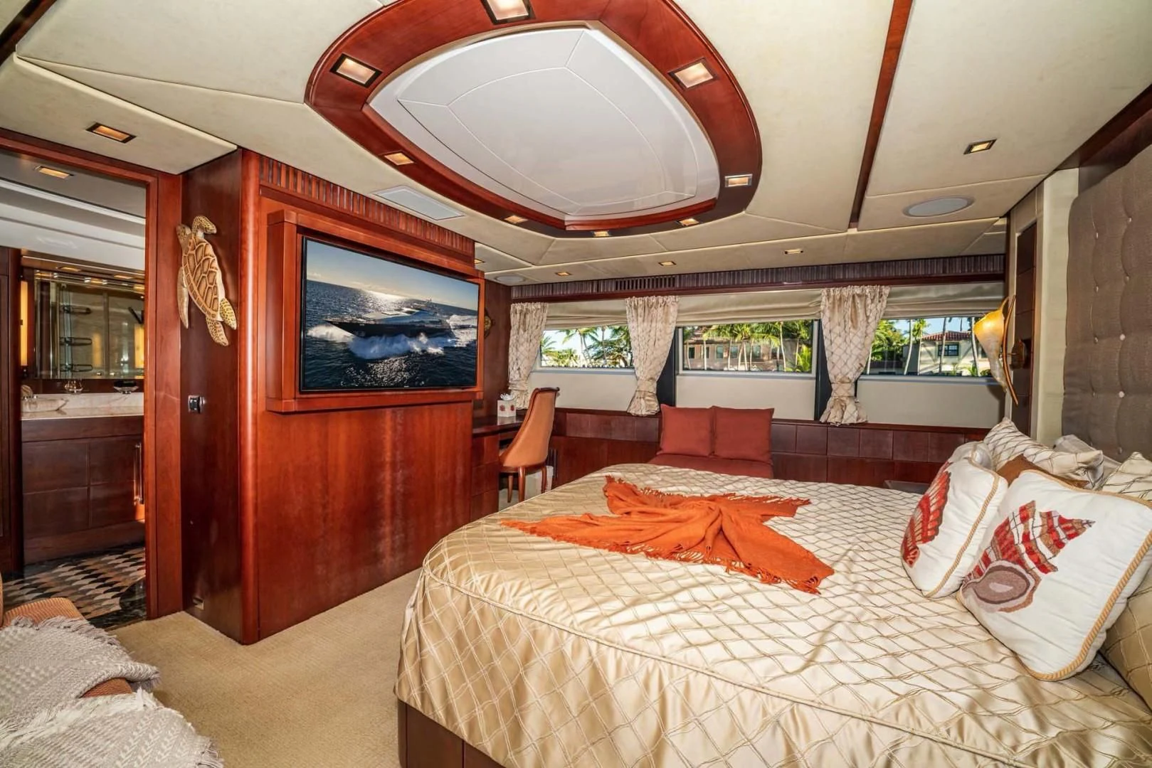 a bedroom with a bed and a chair aboard VIVERE Yacht for Sale