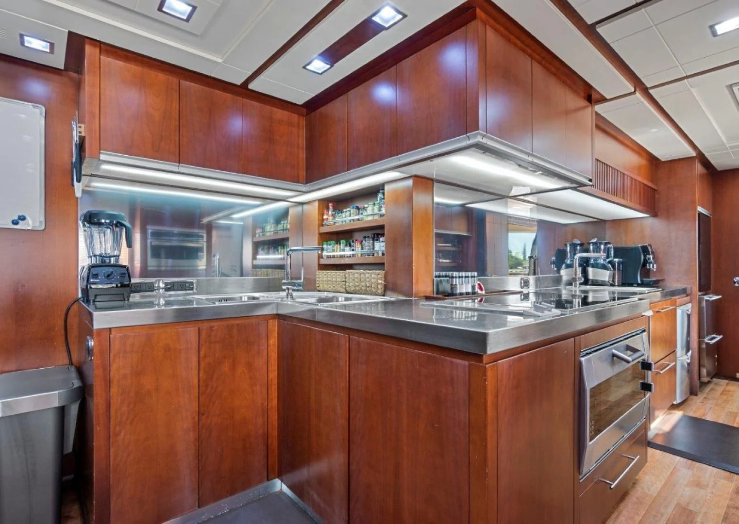 a kitchen with wooden cabinets aboard VIVERE Yacht for Sale