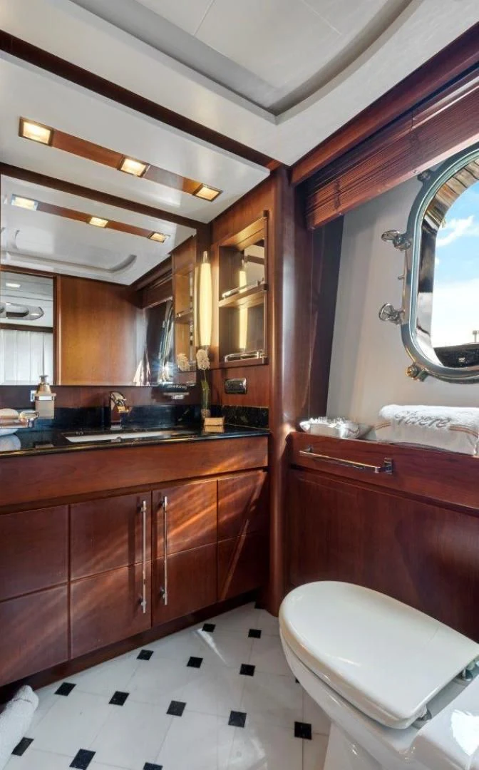 a bathroom with a toilet and a sink aboard VIVERE Yacht for Sale