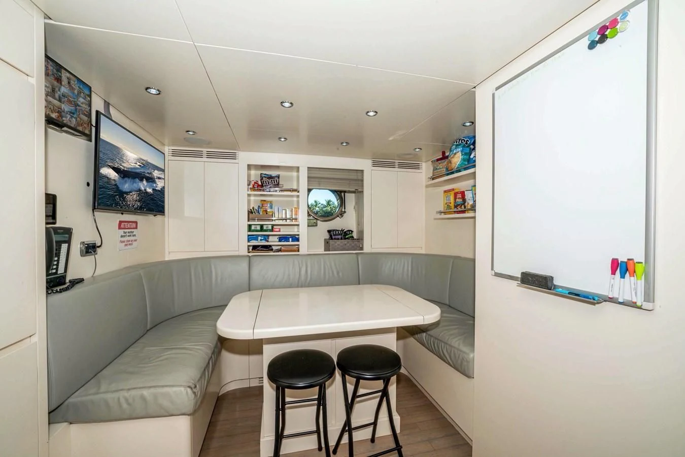 a room with a table and chairs aboard VIVERE Yacht for Sale