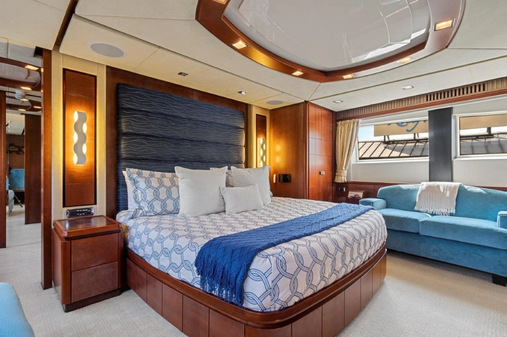 a room with a bed and a couch aboard VIVERE Yacht for Sale