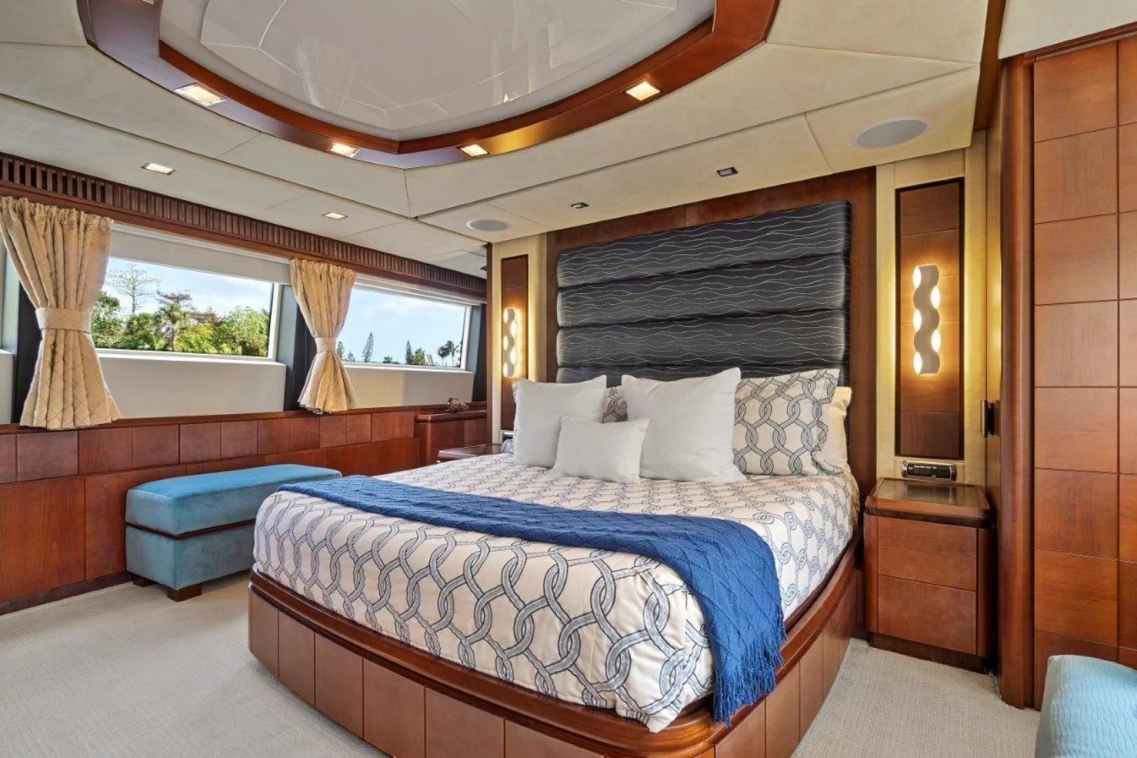 a bedroom with a bed and a large window aboard VIVERE Yacht for Sale