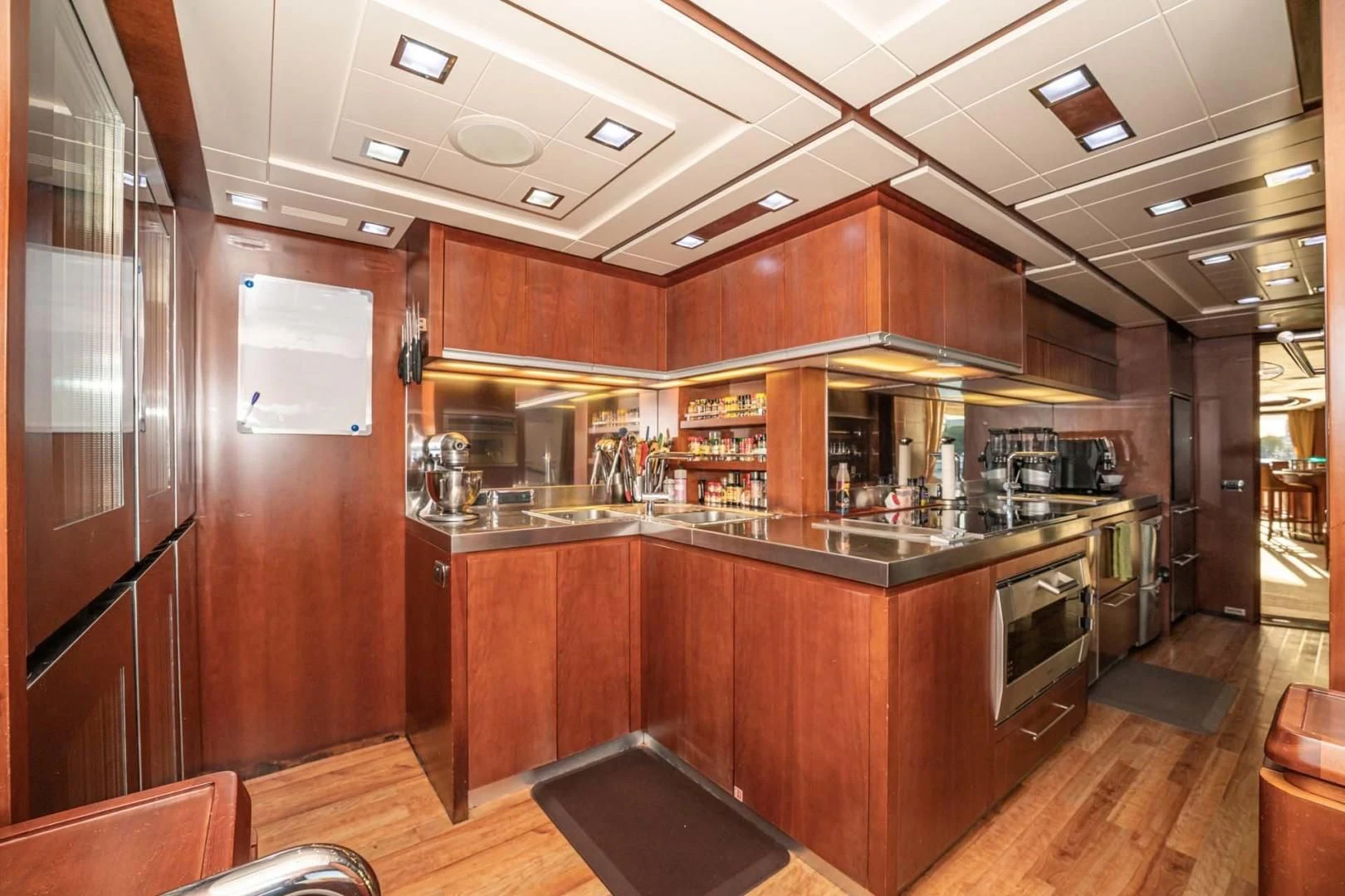 a kitchen with wooden cabinets aboard VIVERE Yacht for Sale