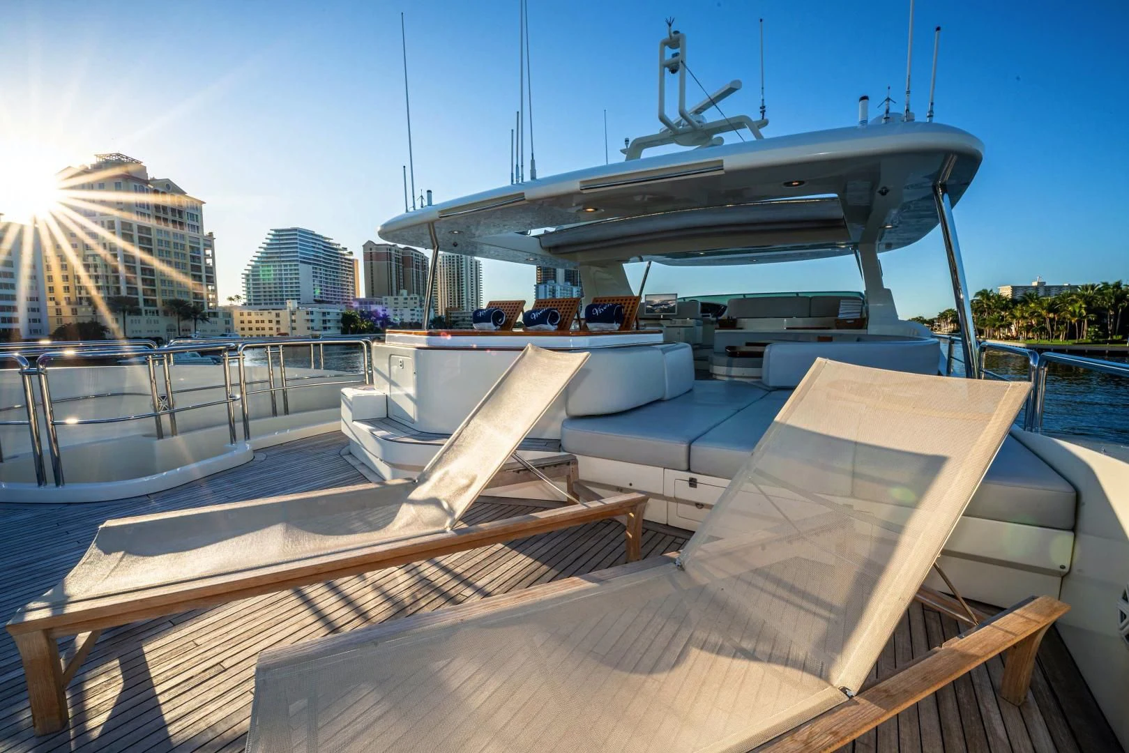 a deck with a large building in the background aboard VIVERE Yacht for Sale