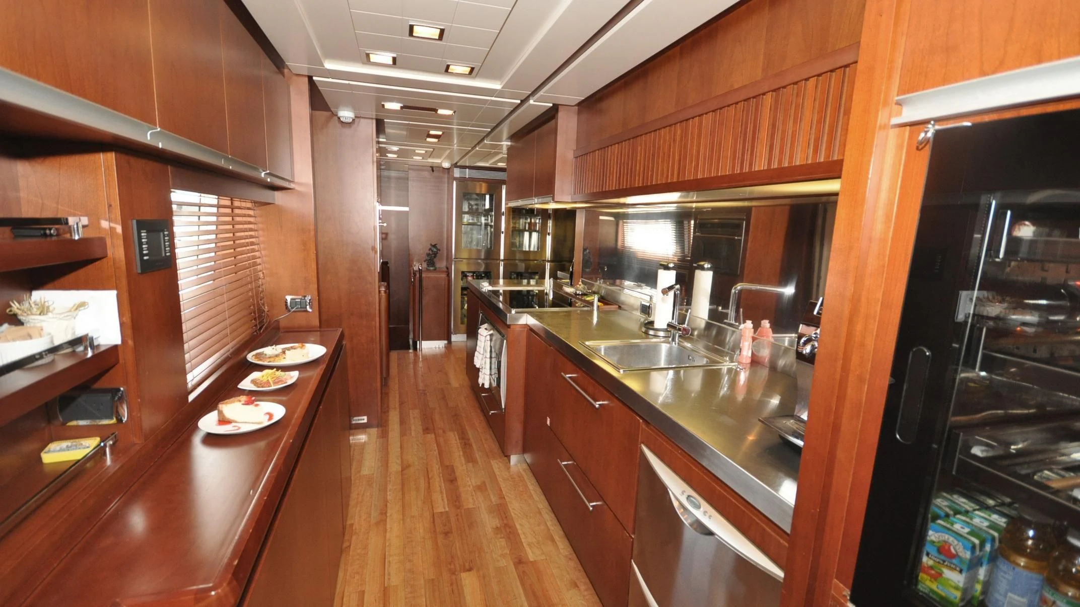 a kitchen with wooden cabinets aboard VIVERE Yacht for Sale