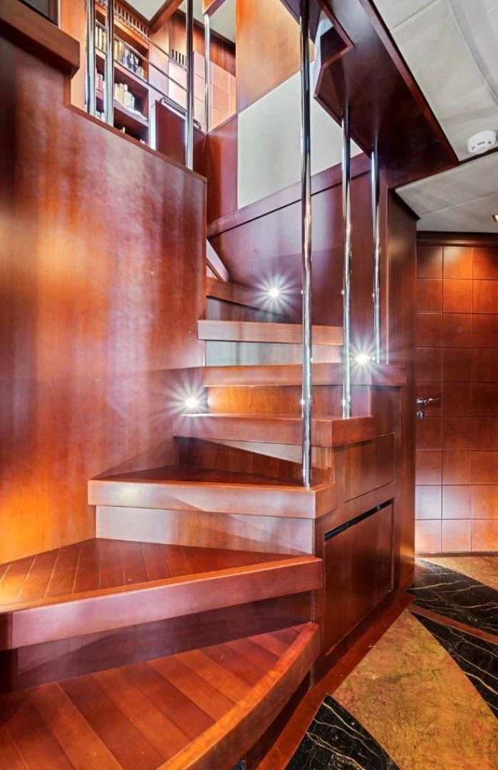 a staircase with a glass window aboard VIVERE Yacht for Sale