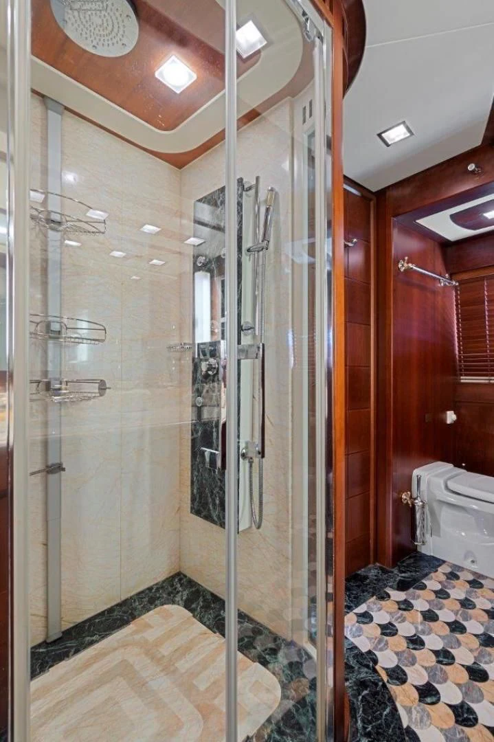 a bathroom with a glass shower aboard VIVERE Yacht for Sale