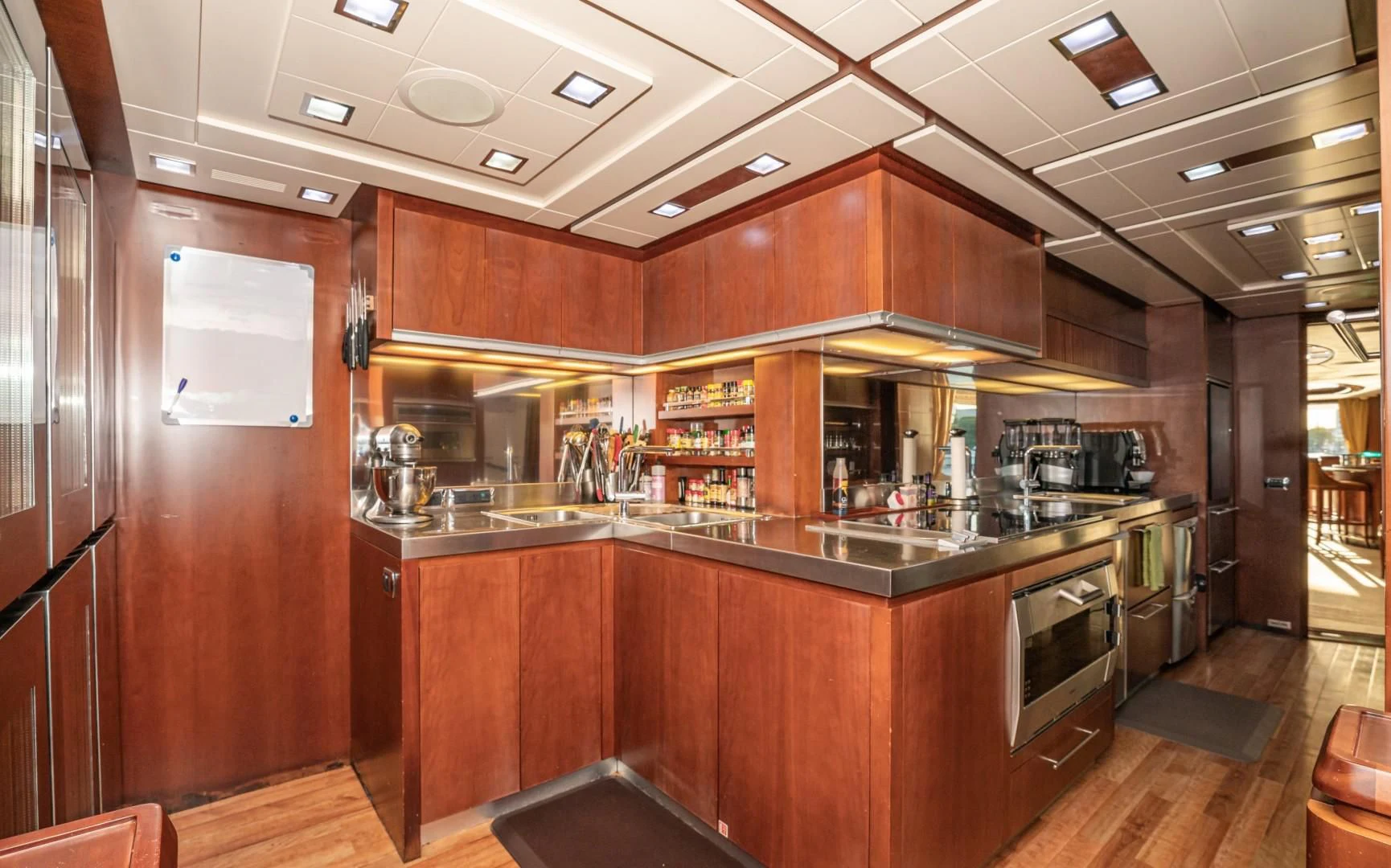 a kitchen with wooden cabinets aboard VIVERE Yacht for Sale