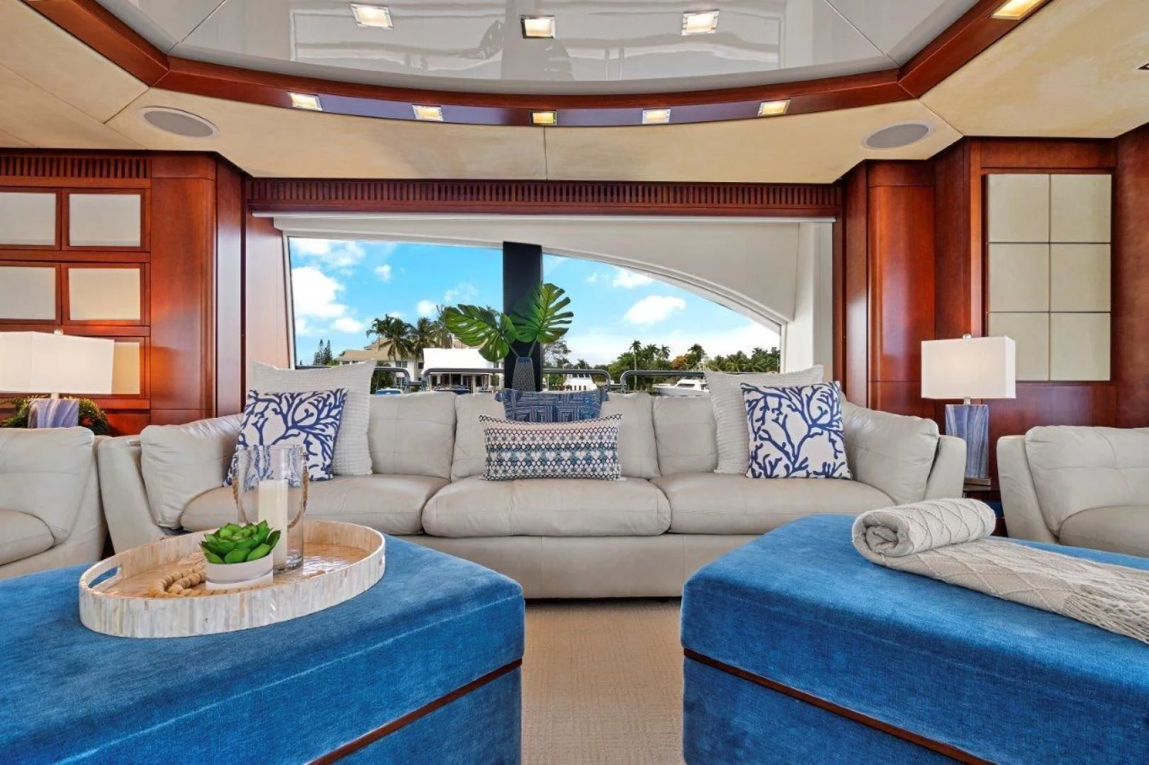 a living room with a large blue table and white couches aboard VIVERE Yacht for Sale