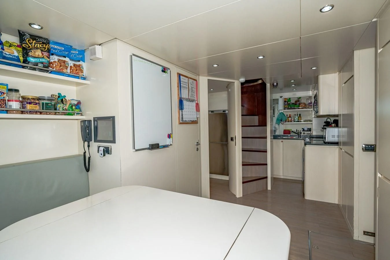 a large kitchen with a large white table and a large white counter aboard VIVERE Yacht for Sale