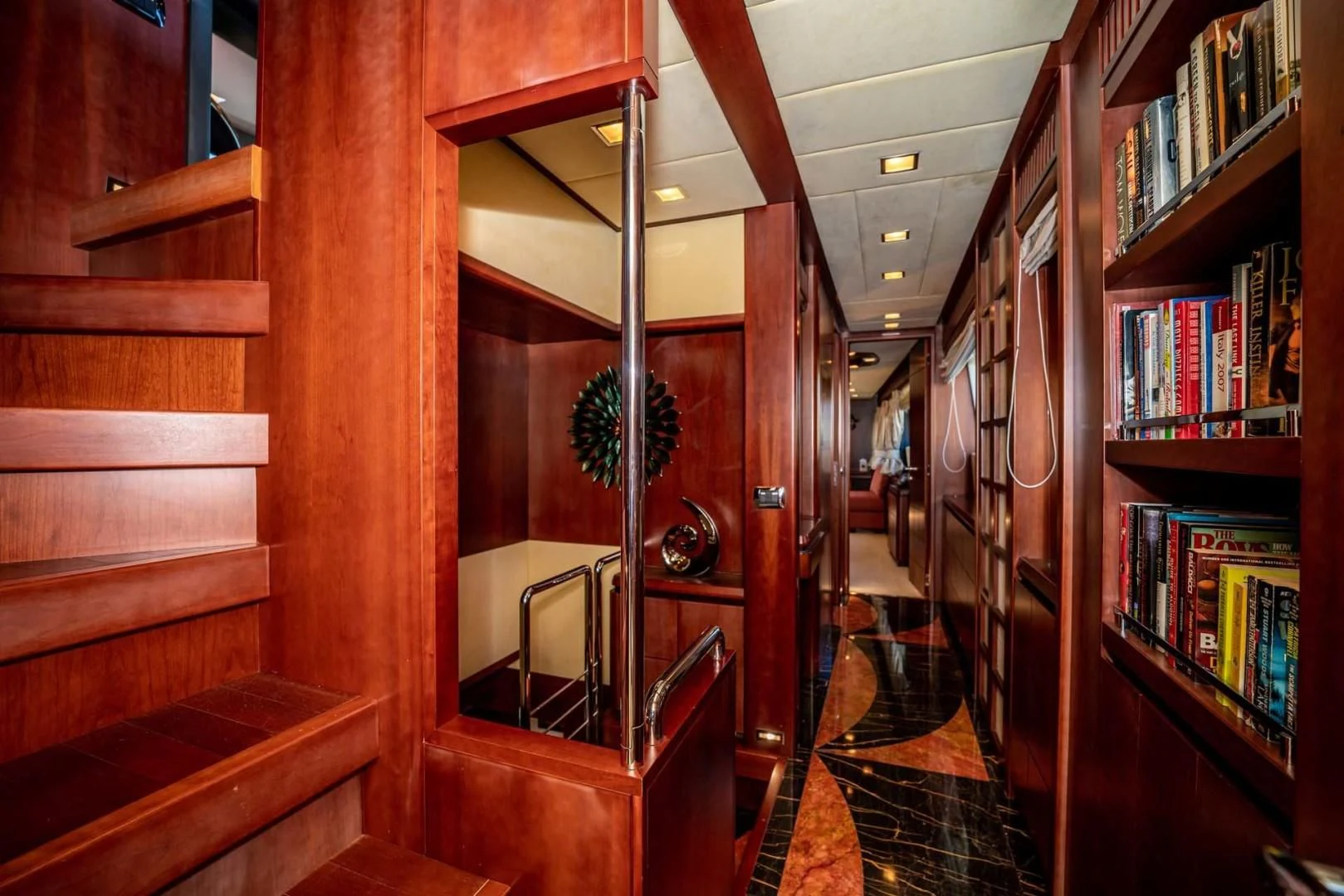 a hallway with bookshelves aboard VIVERE Yacht for Sale