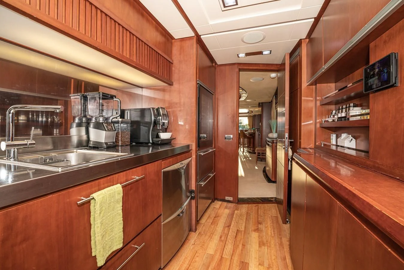 a kitchen with wooden cabinets aboard VIVERE Yacht for Sale