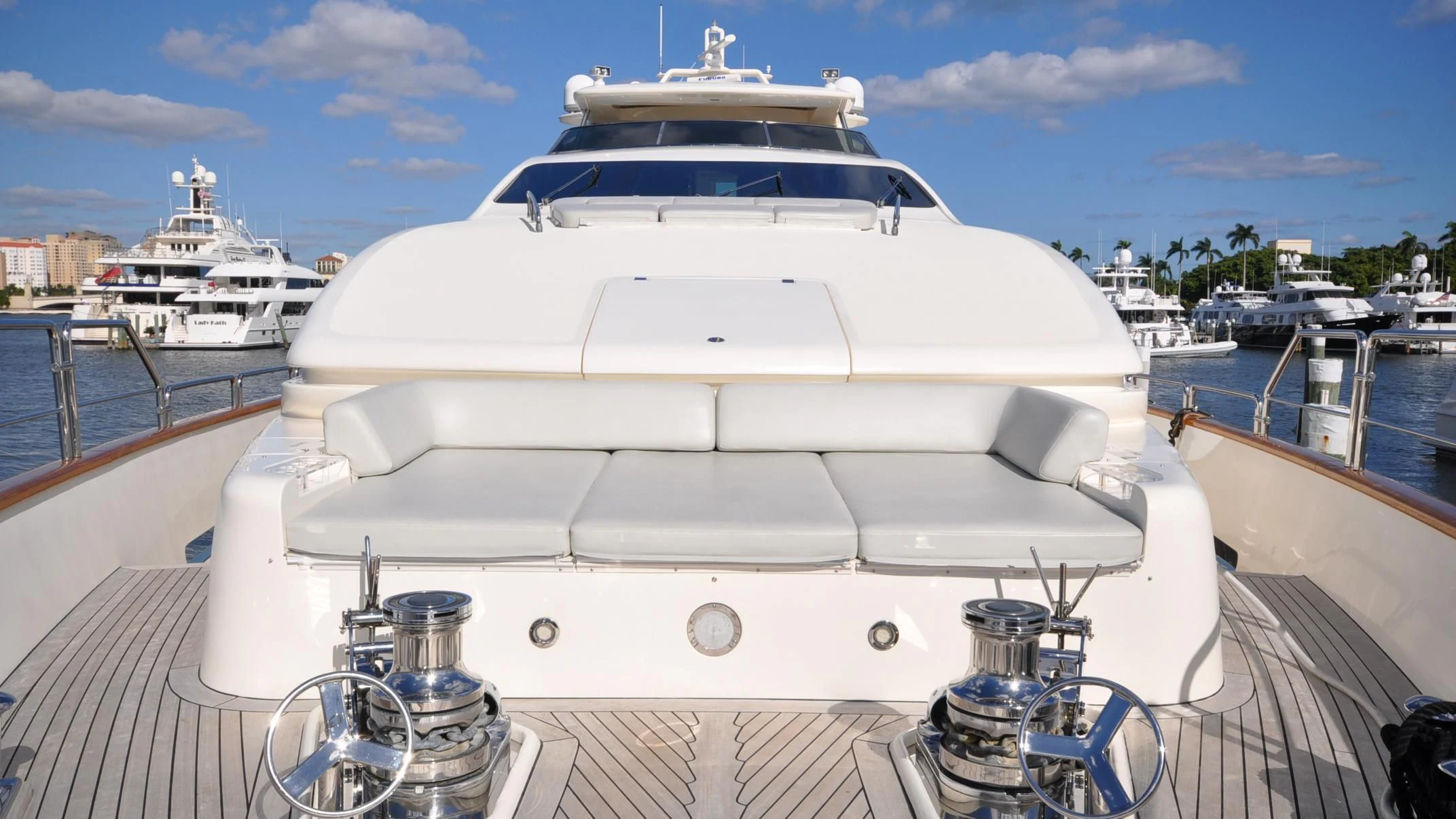 a white yacht docked at a pier aboard VIVERE Yacht for Sale