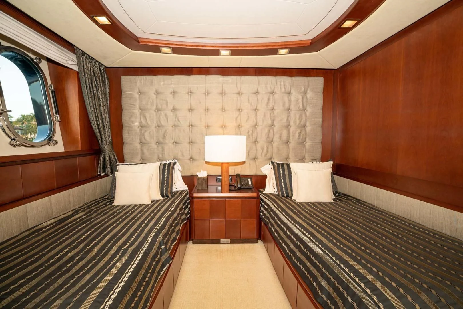 a room with a bed and a mirror aboard VIVERE Yacht for Sale