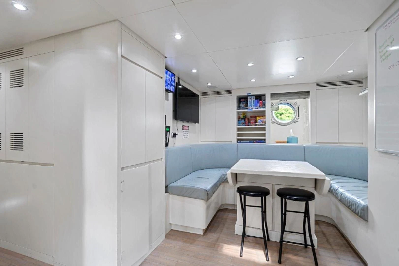 a room with a table and chairs aboard VIVERE Yacht for Sale