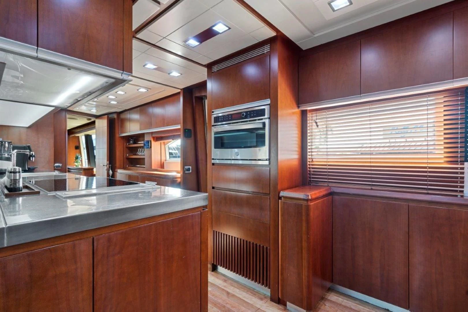a kitchen with wooden cabinets aboard VIVERE Yacht for Sale