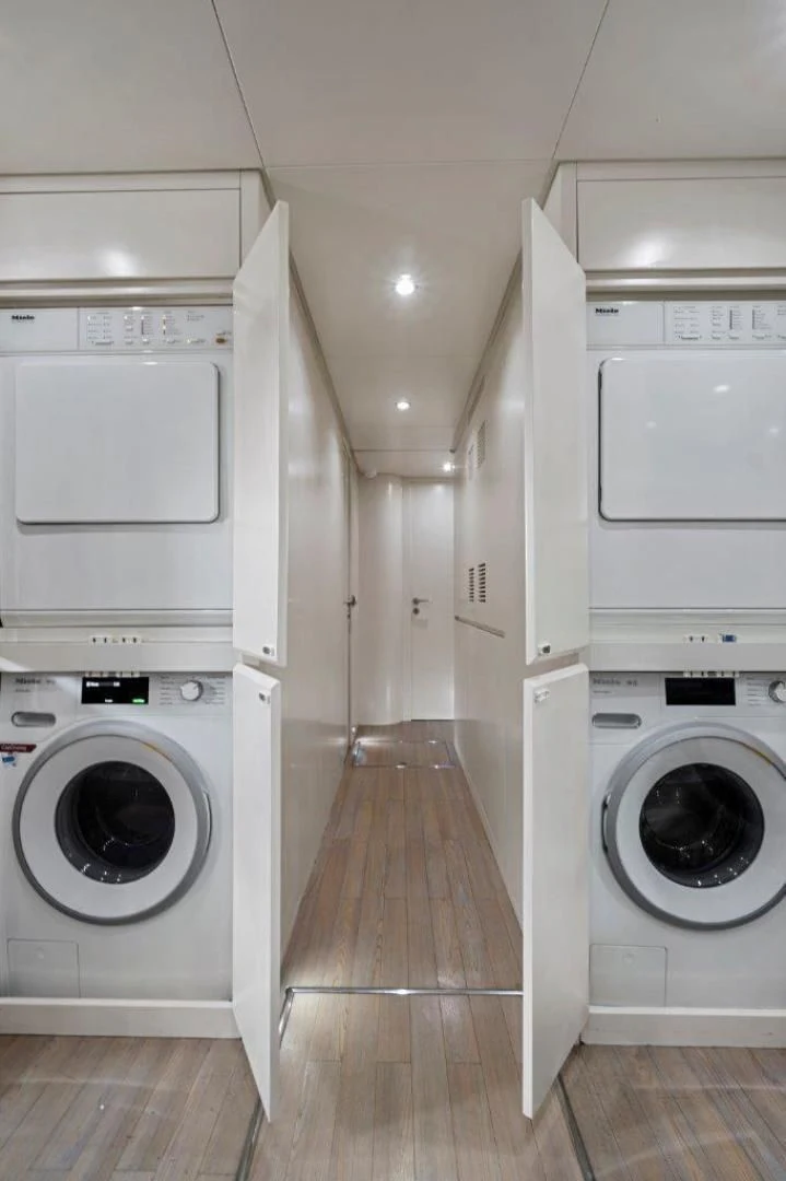 a room with white washing machines aboard VIVERE Yacht for Sale