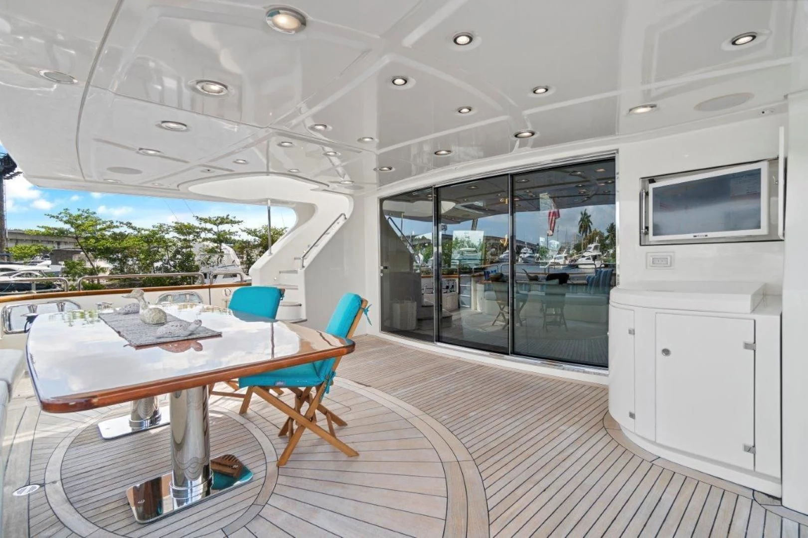 a large room with a table and chairs aboard VIVERE Yacht for Sale