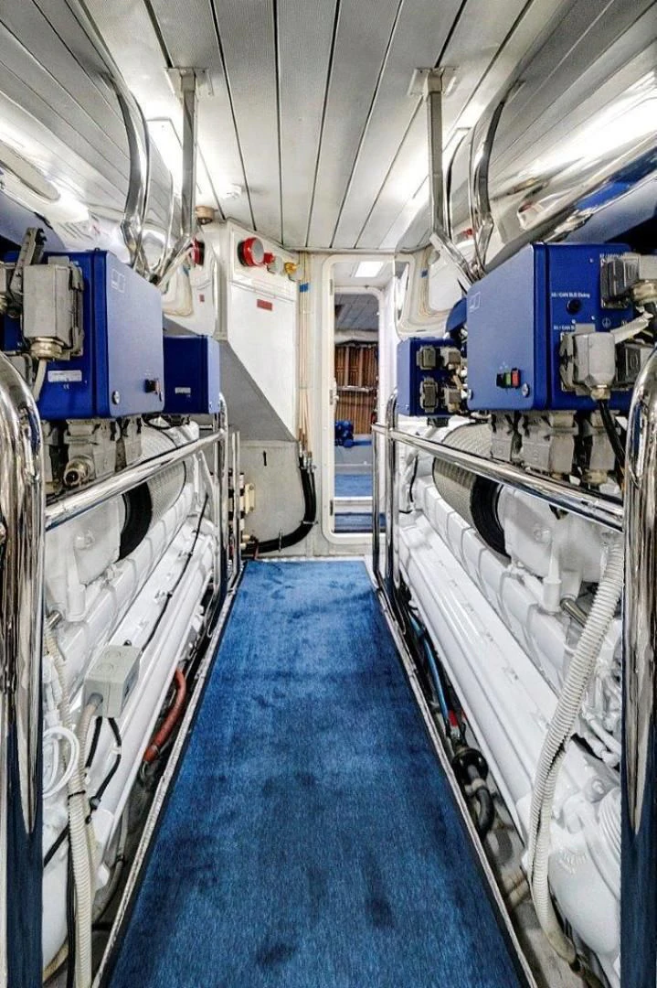 a room with blue carpet and white walls aboard VIVERE Yacht for Sale