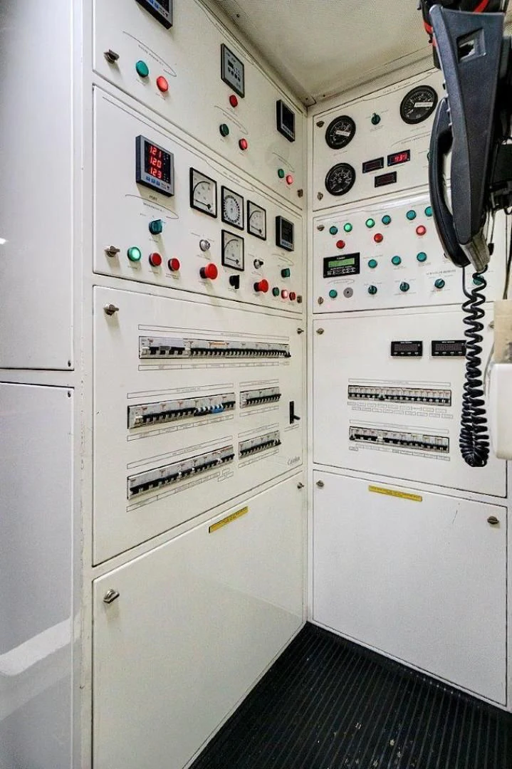 a white cabinet with buttons and knobs aboard VIVERE Yacht for Sale