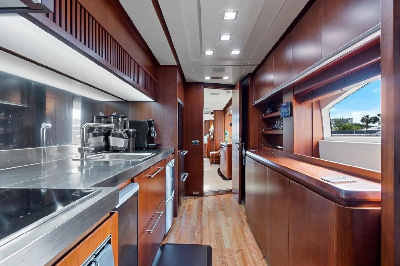 a kitchen with wooden cabinets aboard VIVERE Yacht for Sale