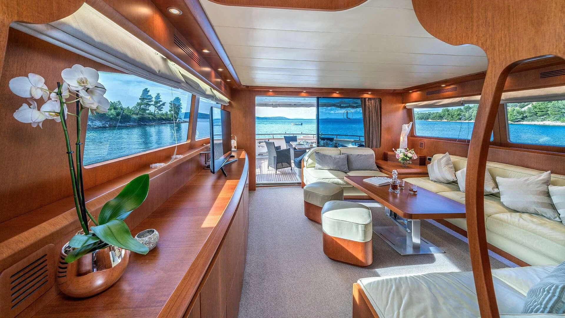 a room with a bed and a table aboard JANTAR Yacht for Charter