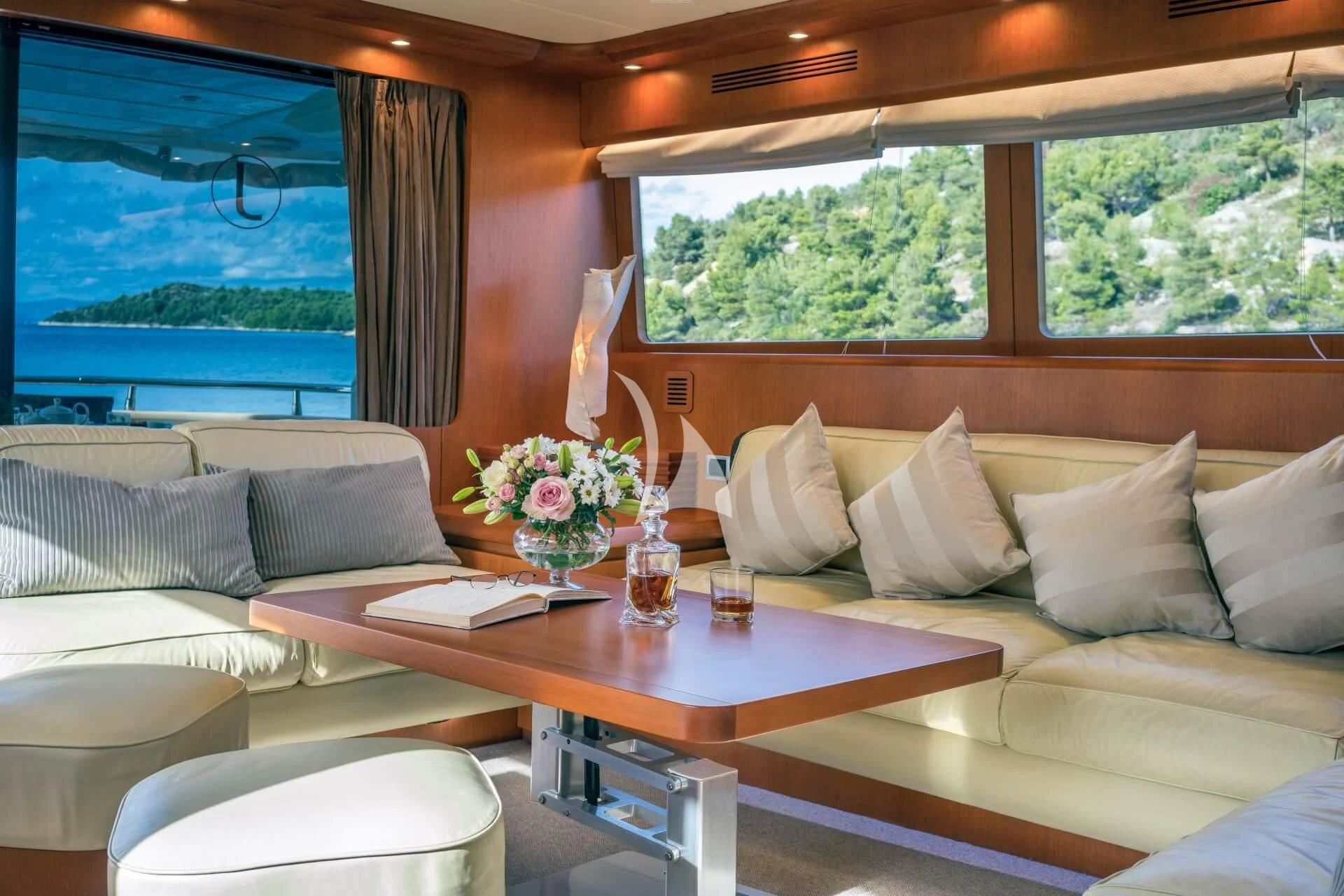 a living room with a table and couches aboard JANTAR Yacht for Charter