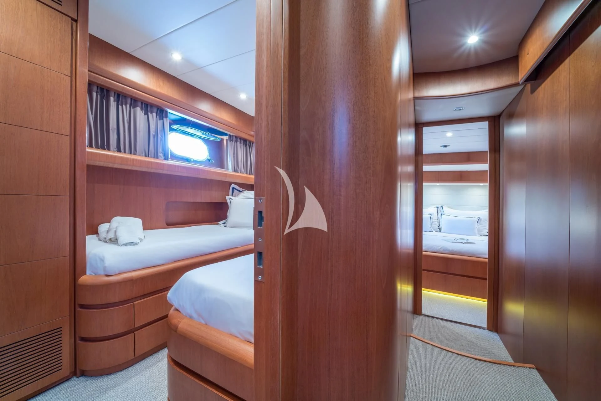 a room with a bed and a closet aboard JANTAR Yacht for Charter